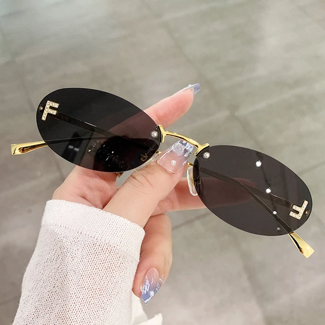 2023 Cat Eye Sun Glasses Female Outdoor Shopping Shades Rimless Driving Eyewear Glasses Retro Letter Oval Sun Glasses Shades 1